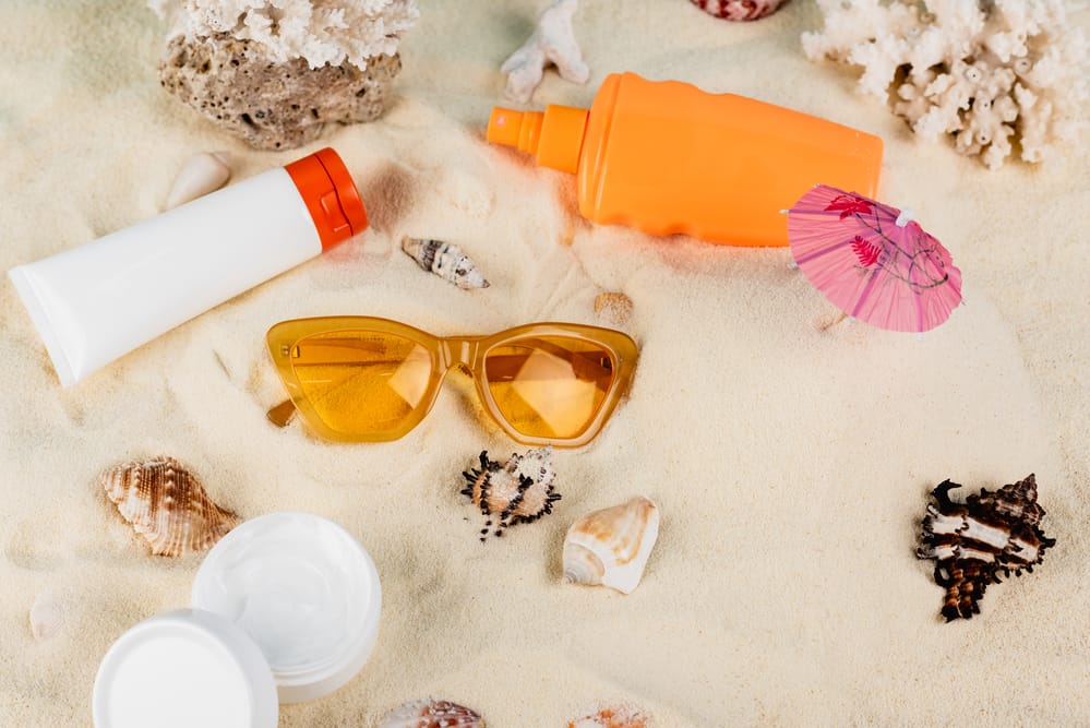 Top view of containers with sunscreen and cosmetic cream