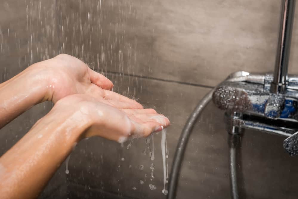 Water drops falling on female hands