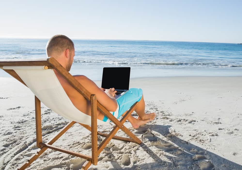 Relaxed handsome man working on his laptop